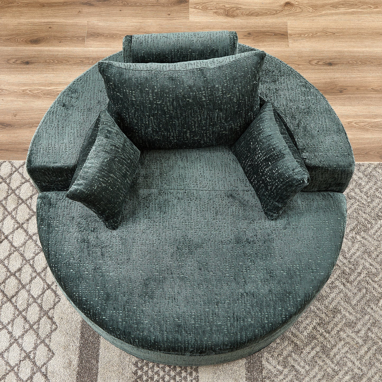 Deep teal textured fabric round accent chair with plush cushions and throw pillows