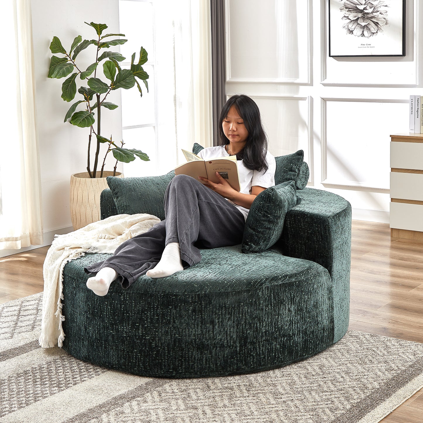 Deep green velvet circular accent chair with plush cushions and a textured finish