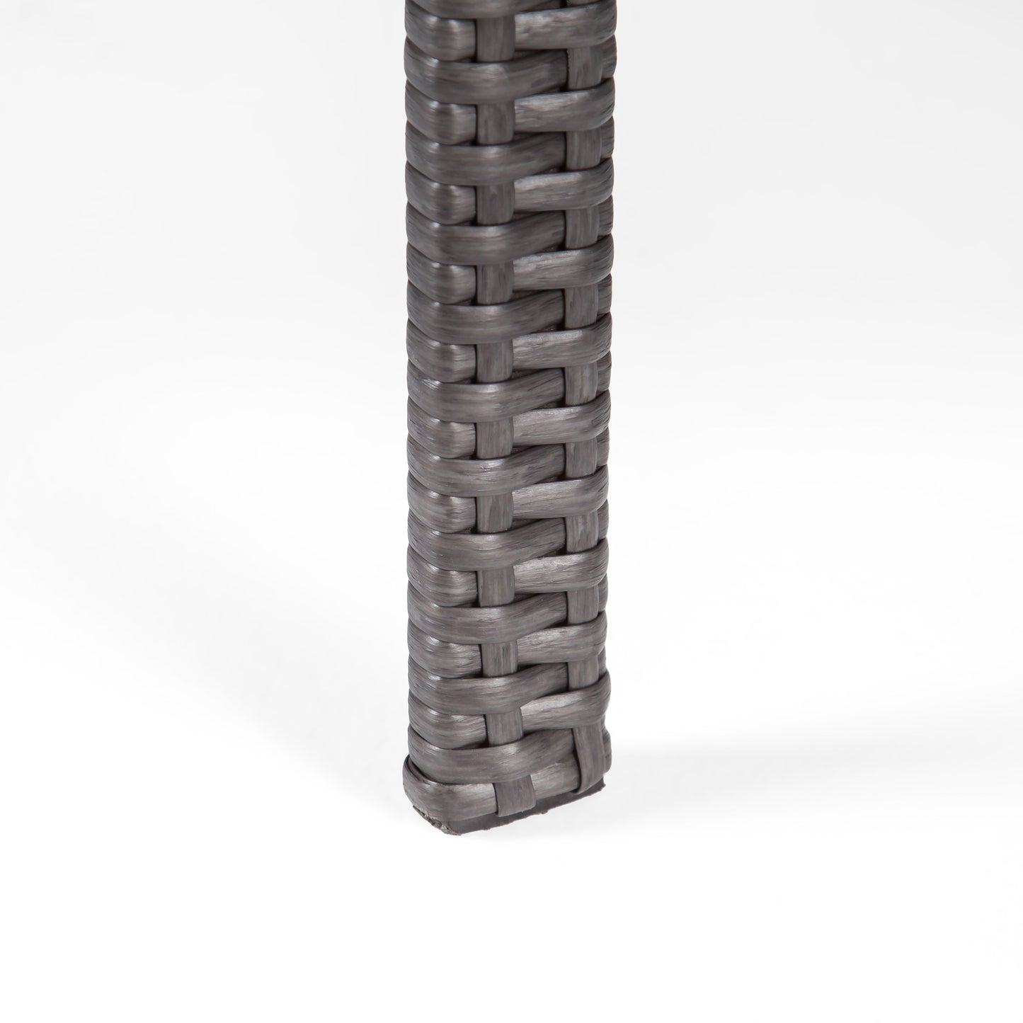 Close up of gray wicker table leg with woven texture