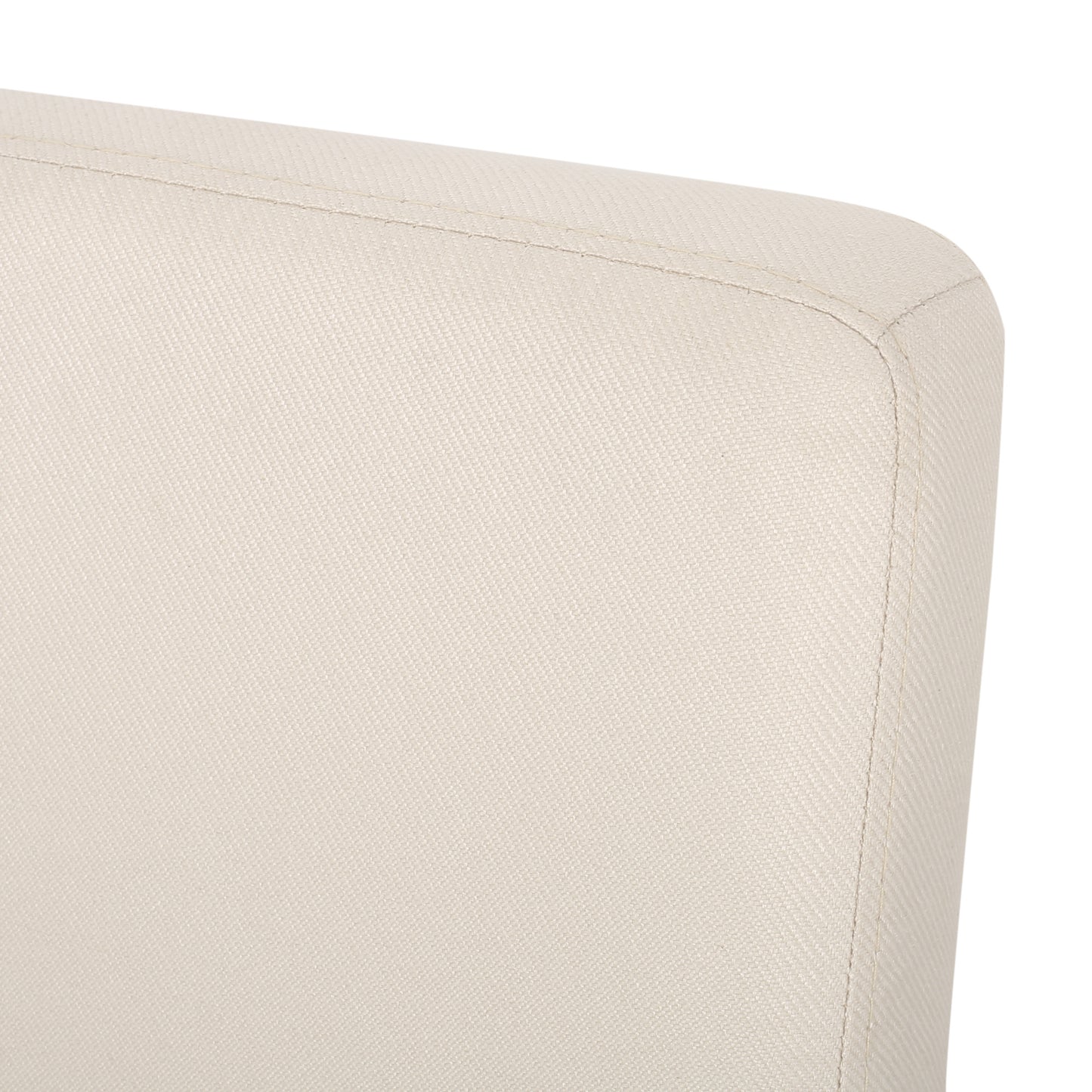 Closeup of textured offwhite fabric on a chairs curved backrest showing stitching detail