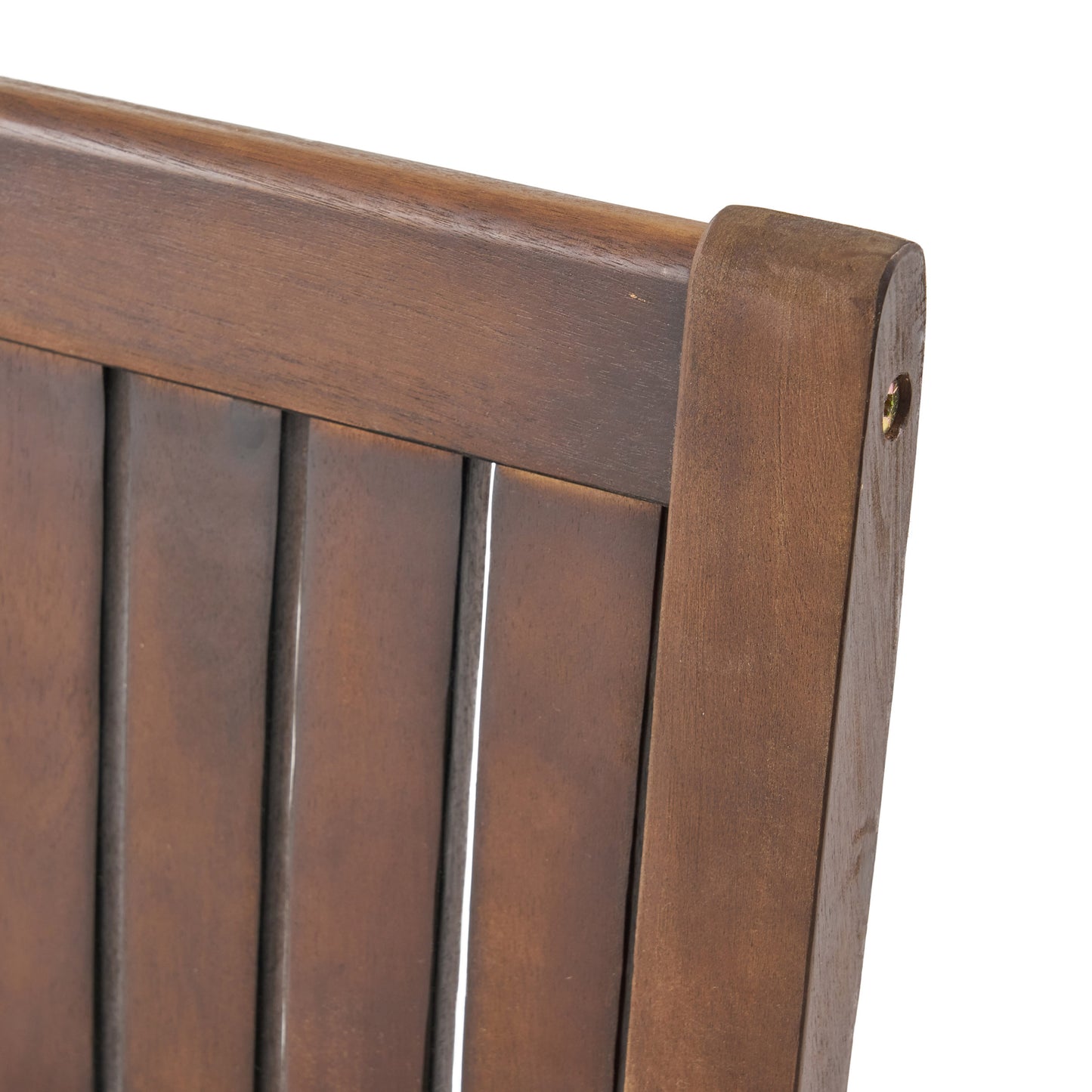 Closeup of a dark brown wooden chair back with vertical slats and visible wood grain texture