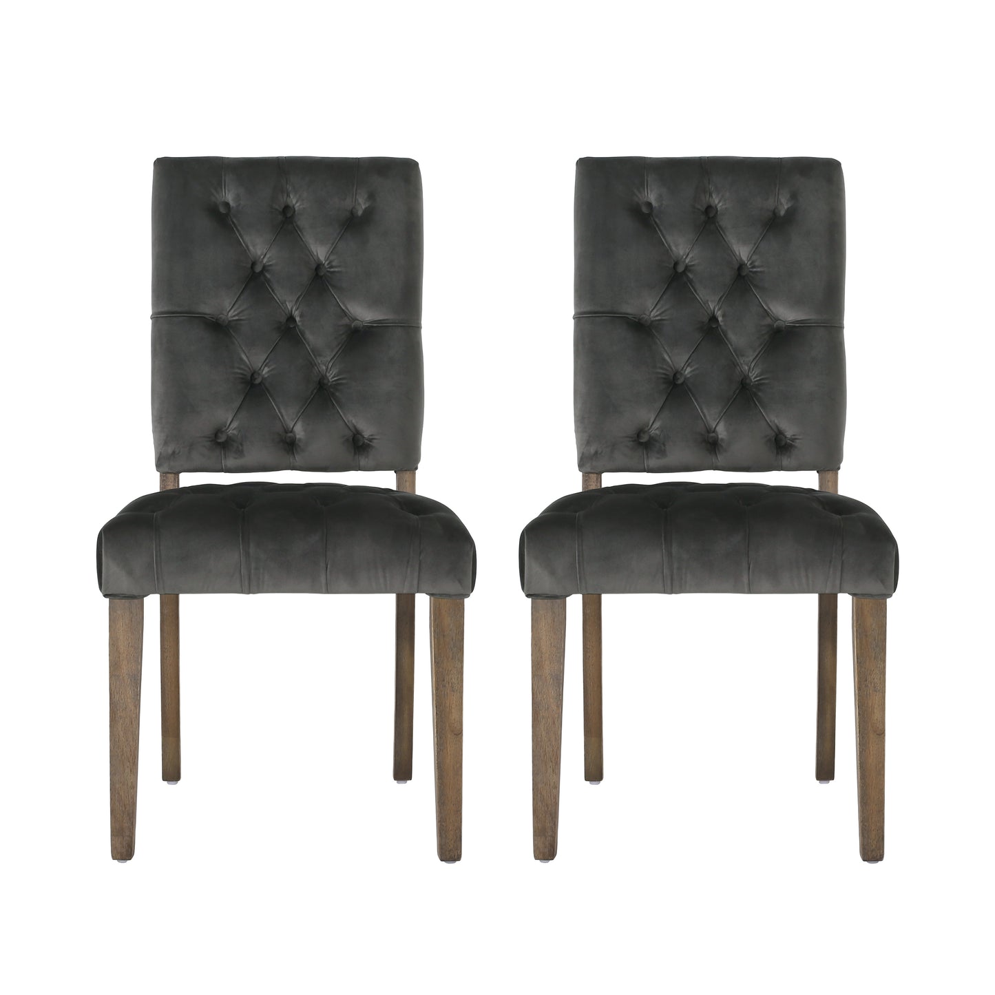Two dark grey velvet dining chairs with tufted backs and wooden legs