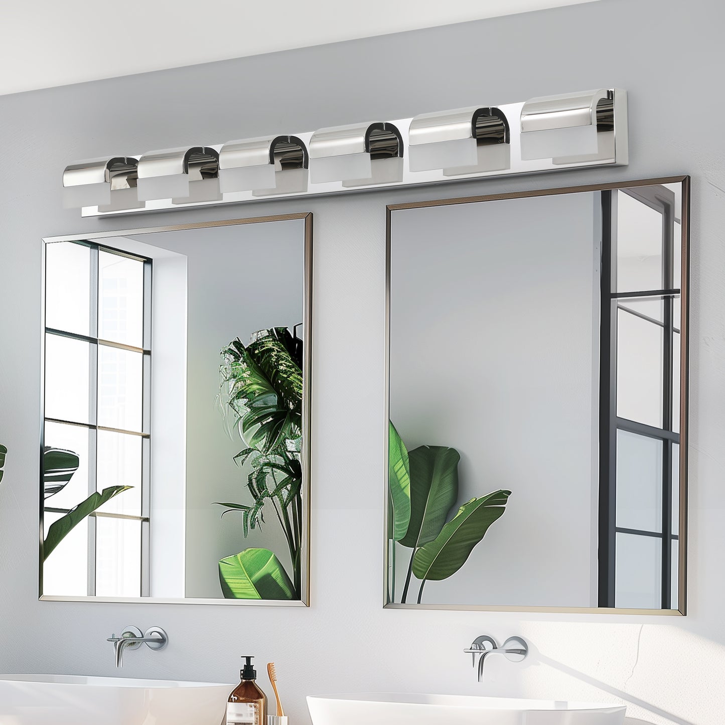 Modern chrome vanity light fixture with five frosted glass shades above a bathroom mirror