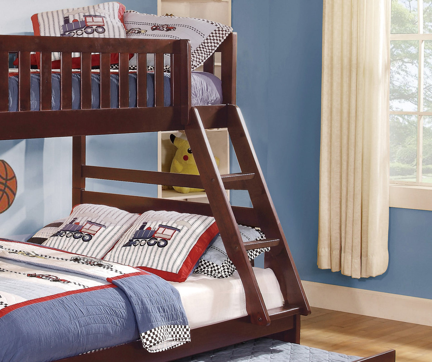 Dark wood bunk bed with trainthemed pillows for childrens room