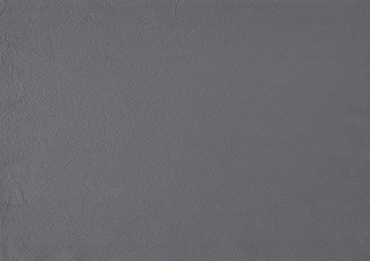 Closeup textured shot of a dark grey felt fabric with a fine fuzzy nap for crafting