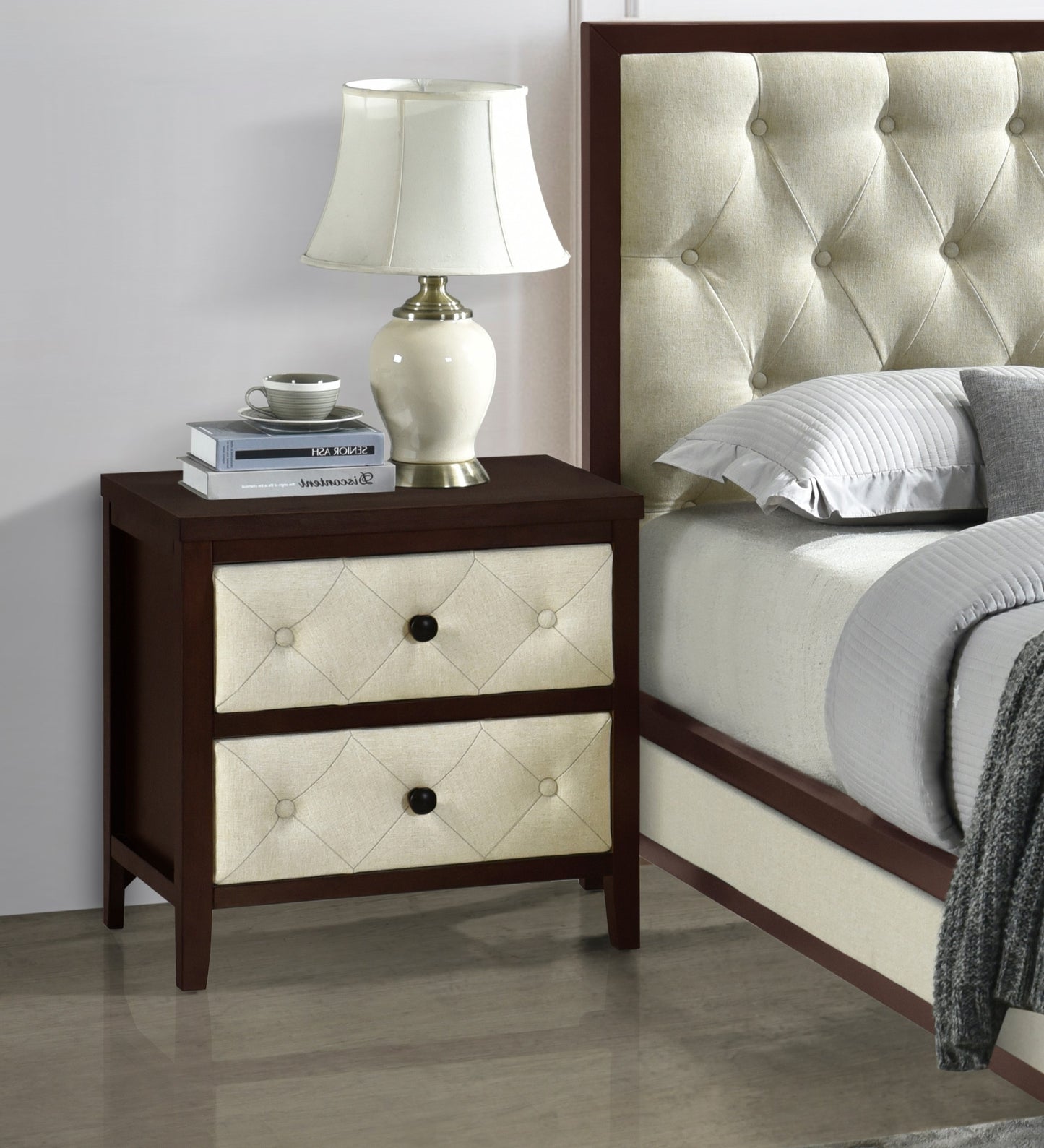 Dark wood nightstand with two cream diamondtufted drawers and black knobs