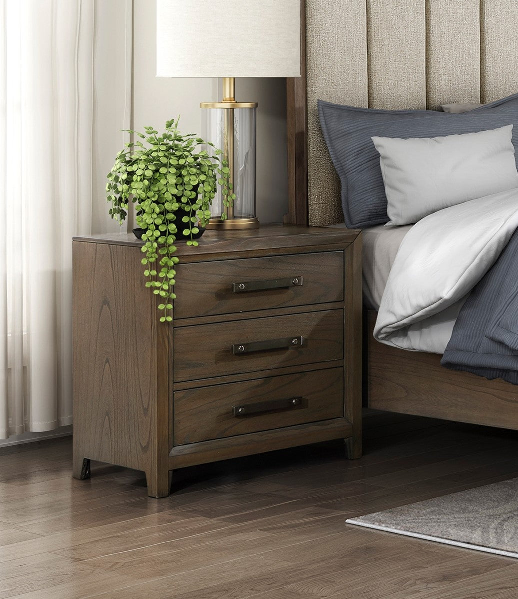 Dark wood nightstand with three drawers and metal pulls beside a bed