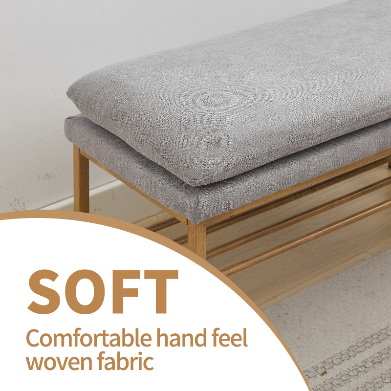 Gray upholstered entryway bench with two wooden slatted shelves