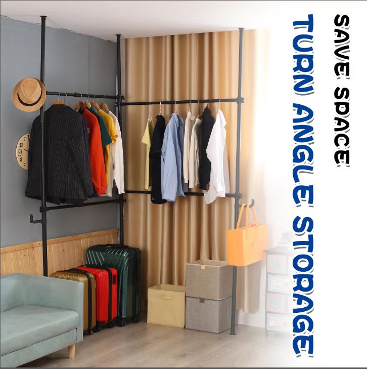 Black metal garment rack with assorted hanging clothes a hat and suitcases