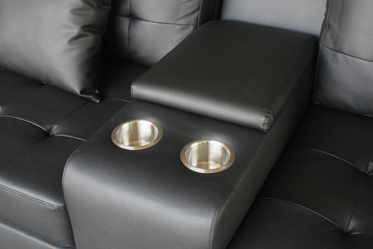 Black faux leather sofa armrest with two stainless steel cup holders for home theater seating