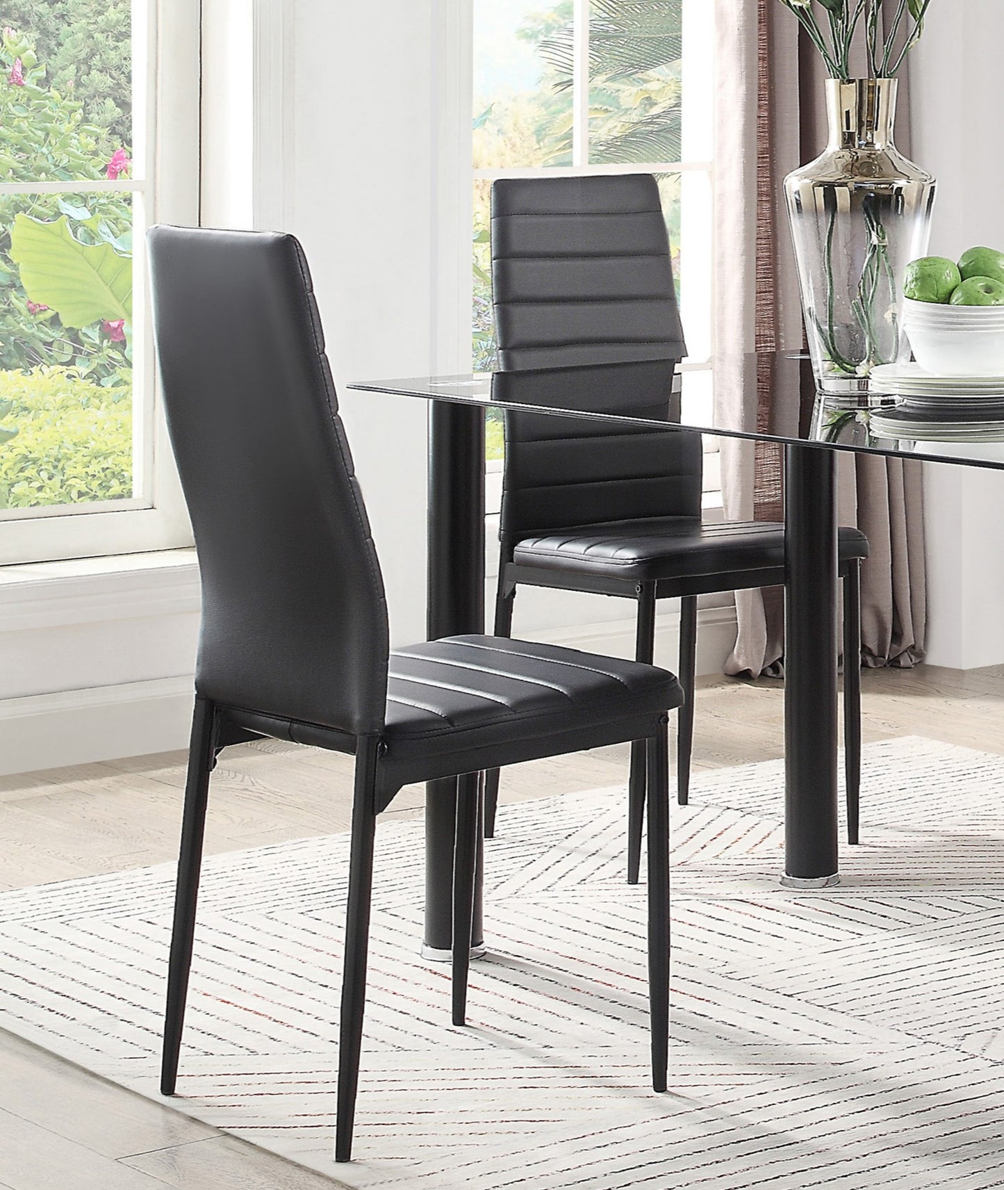 Black faux leather dining chair with quilted backrest and slim metal legs