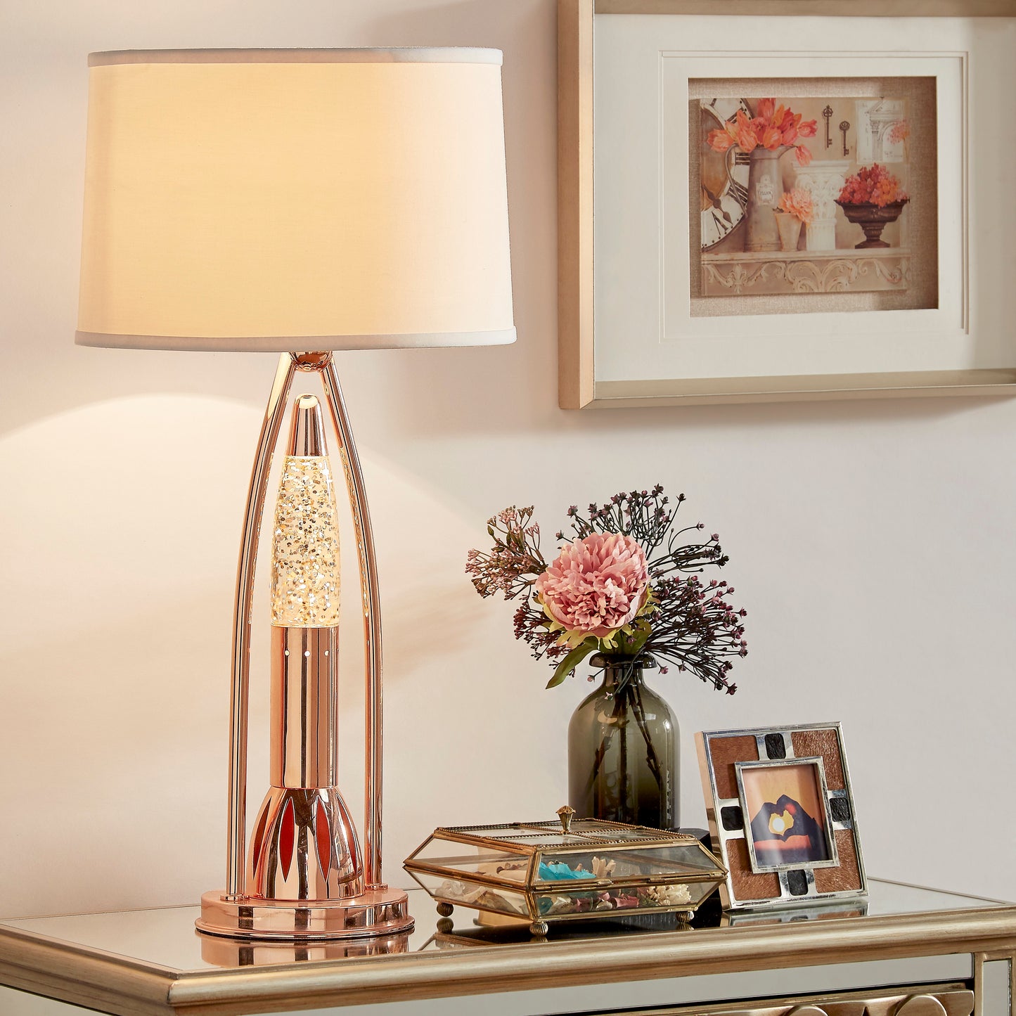 Rose gold table lamp with a faceted crystal accent and a cream fabric shade