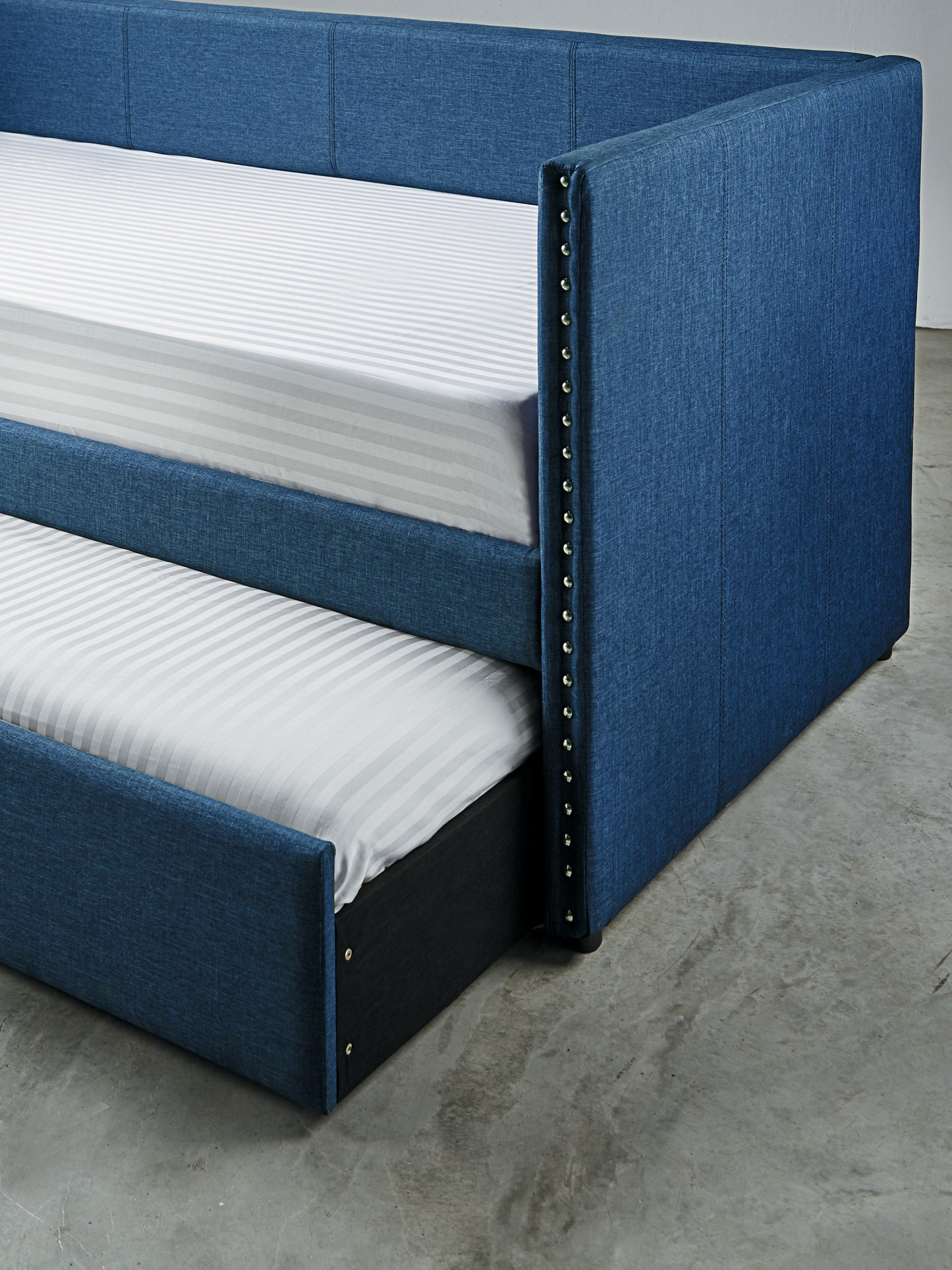 Blue upholstered twin daybed with pullout trundle silver nailhead trim