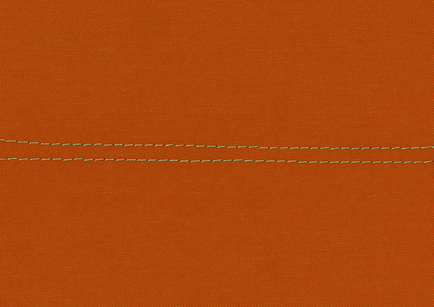 Closeup of burnt orange canvas fabric with double contrasting stitch detail