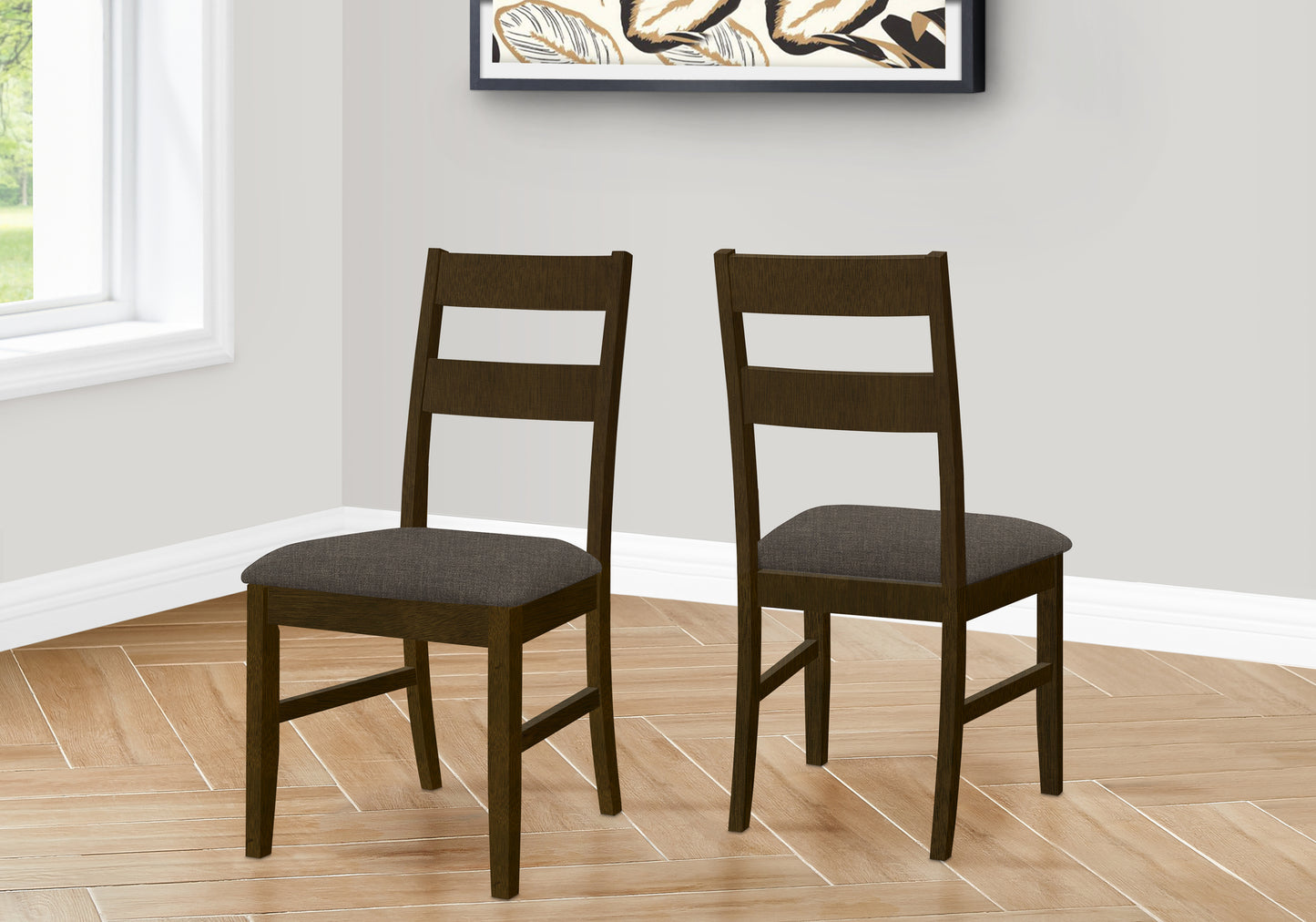 Two dark oak dining chairs with upholstered seats in a modern setting