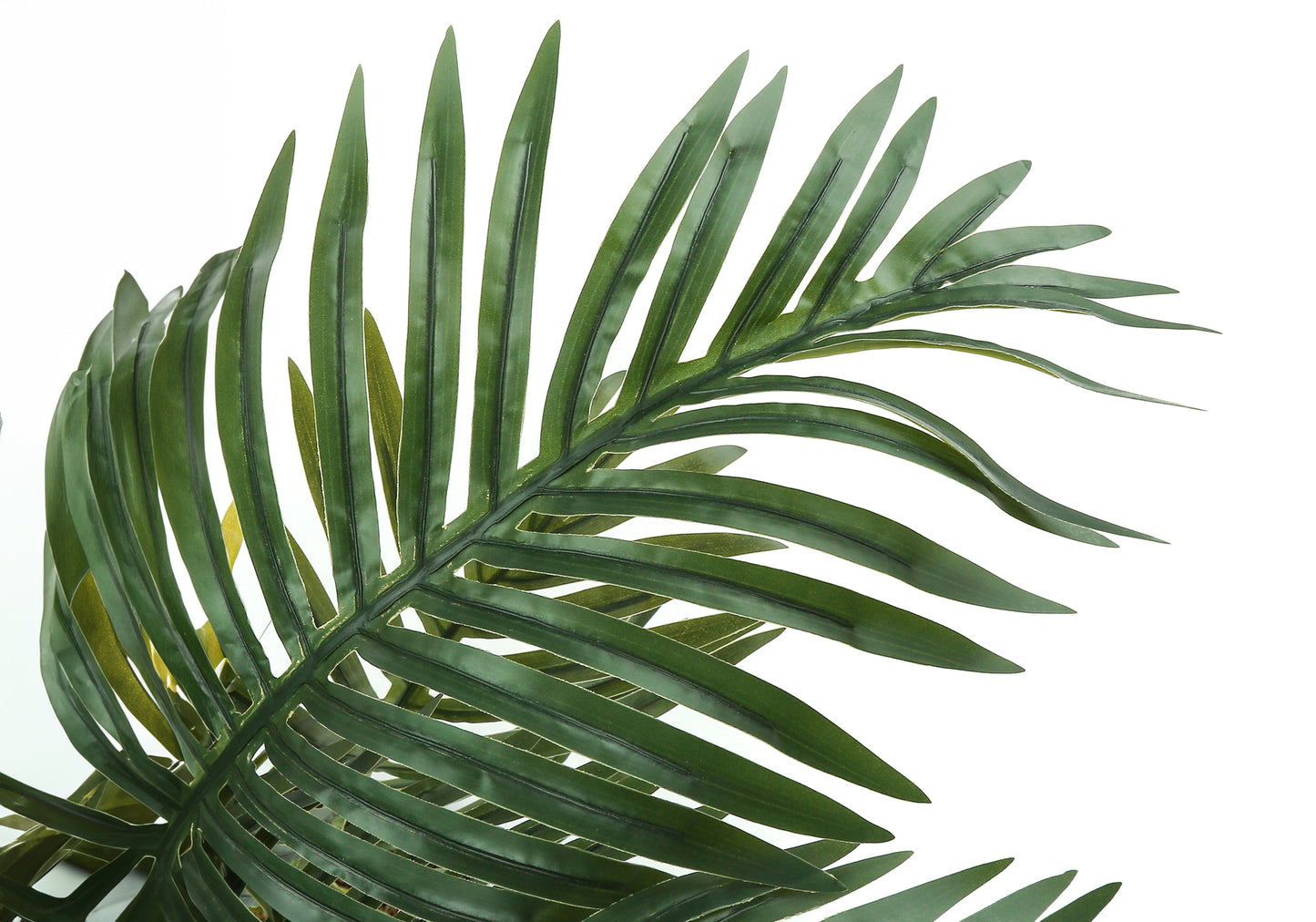 Closeup of a vibrant green artificial palm leaf with detailed veins