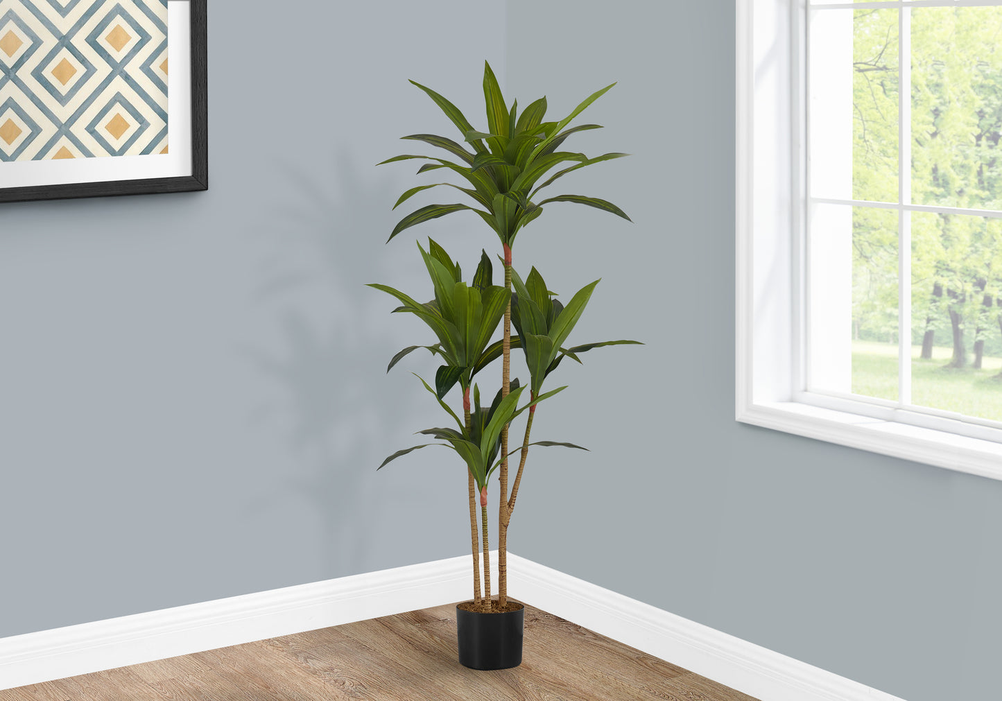 Tall artificial plant with lush green leaves in a black pot for home decor