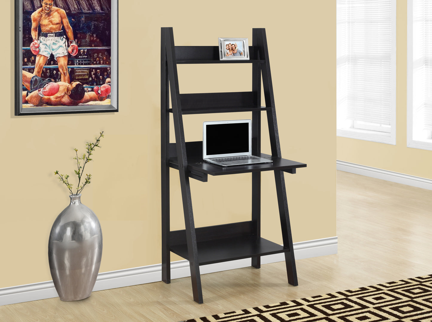 Black ladder desk with laptop and photo frame on shelves