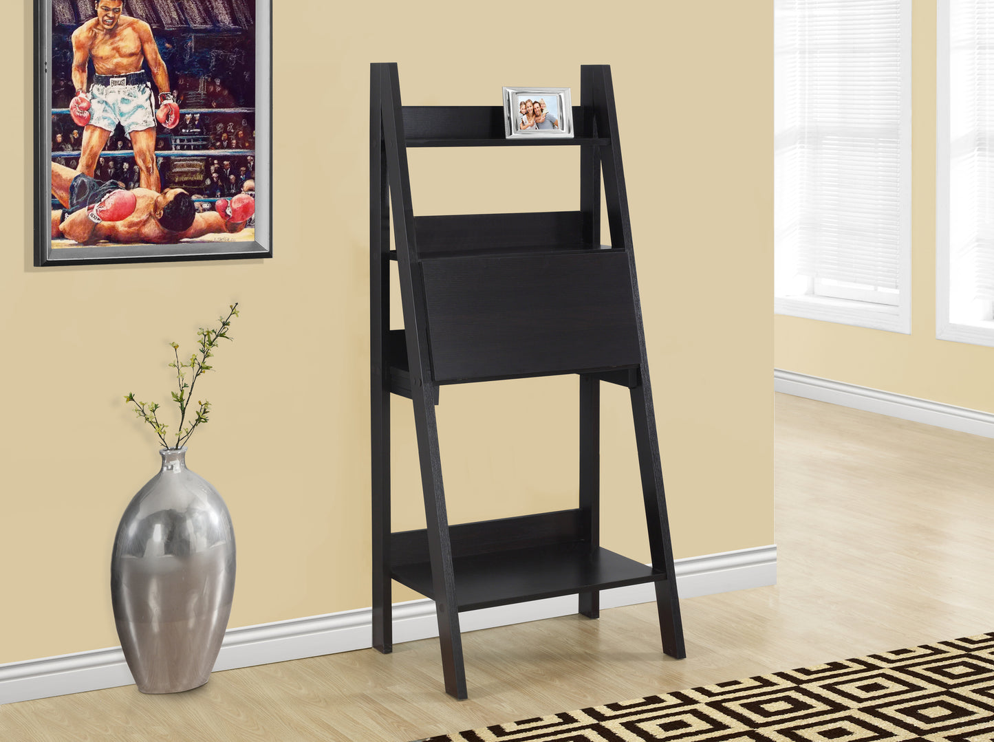 Black leaning bookshelf with open shelves and a builtin drawer for stylish storage