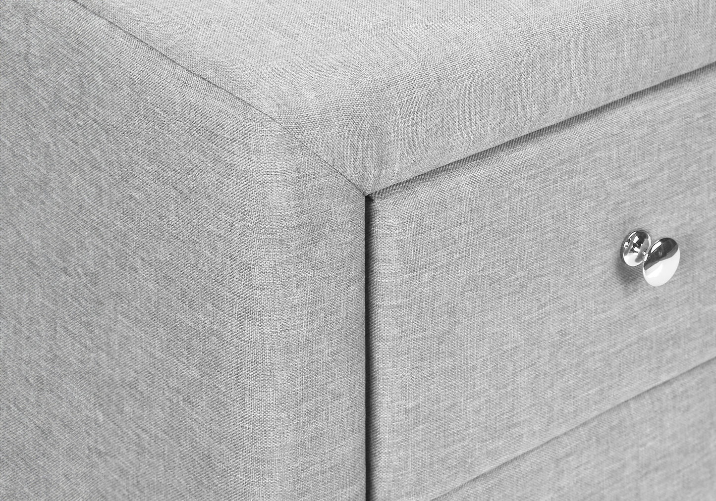 Light grey upholstered storage ottoman with silver knob detail