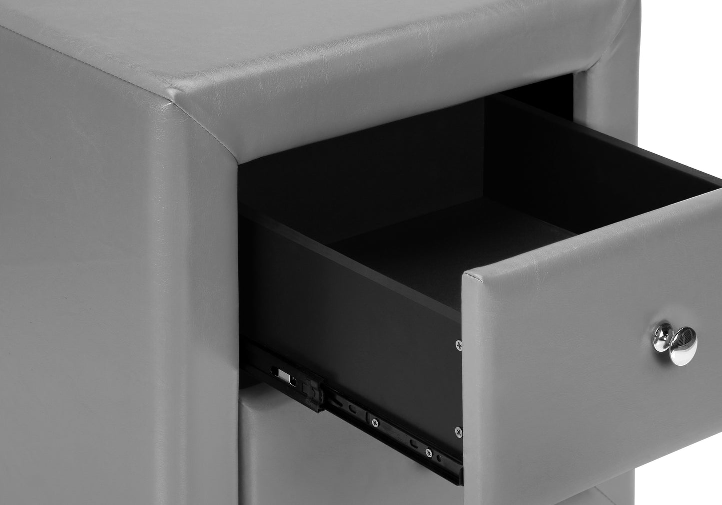 Gray faux leather upholstered nightstand with a partially opened drawer and a chrome knob