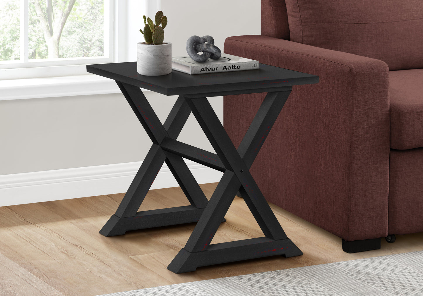 Black wooden Xleg side table with distressed red accents perfect for small spaces