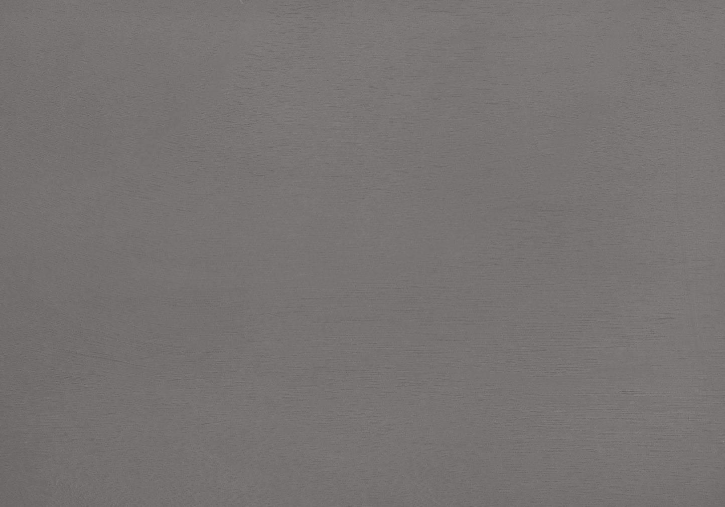 Closeup of textured matte gray paint on a smooth surface