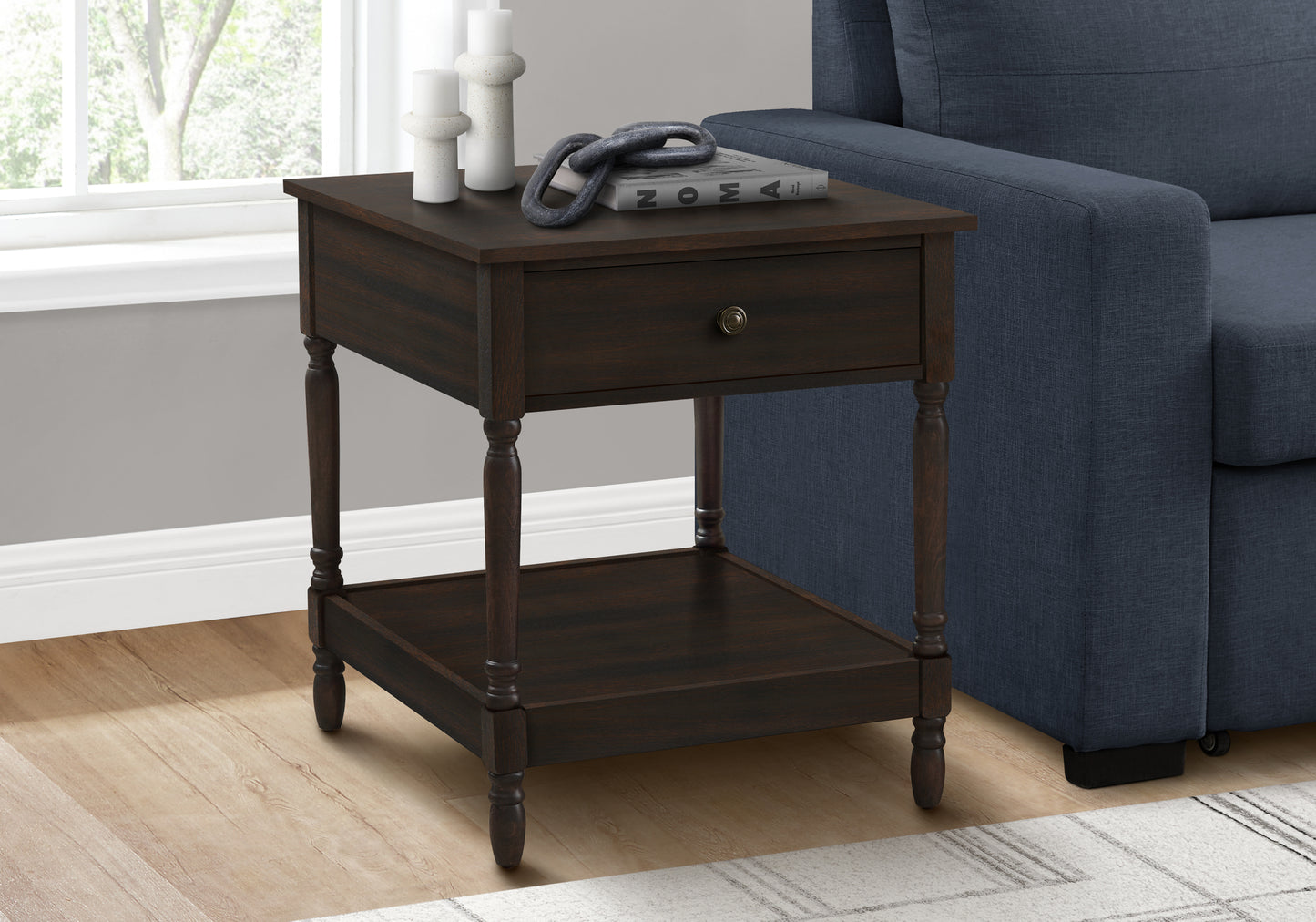 Dark wood end table with drawer and lower shelf featuring turned legs and antique brass knob