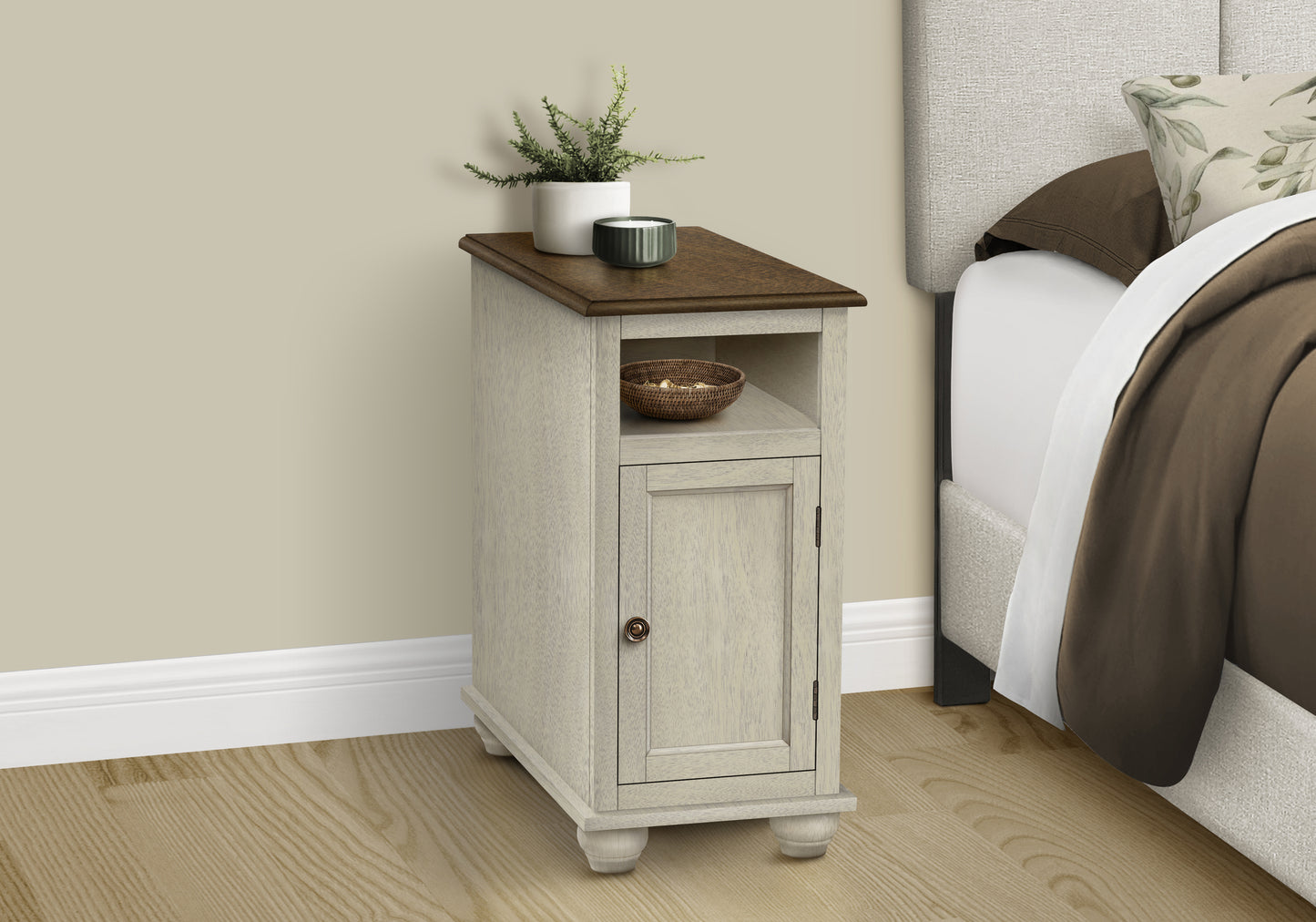 Tall beige bedside table with wooden top and brass knob fits farmhouse style rooms