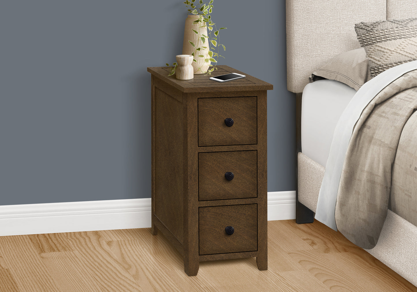 Dark brown wooden nightstand with three drawers and decorative top