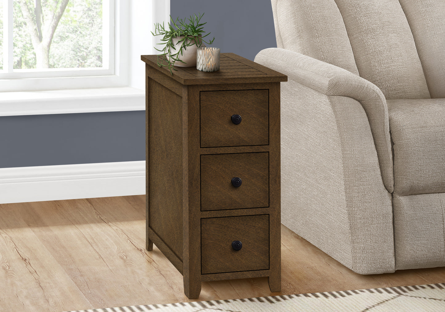 Rustic brown wooden end table with three drawers and black knobs