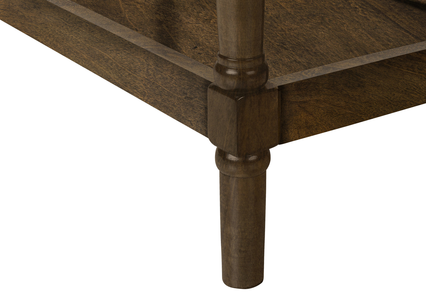 Detail of a dark wood coffee table leg with carved accents