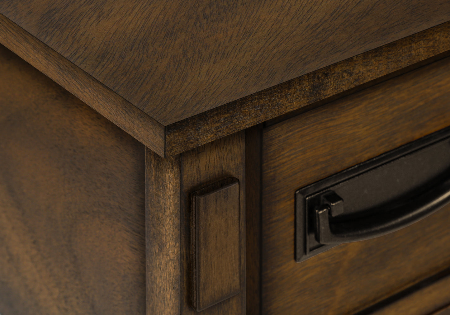 Closeup of dark wood dresser drawer with antique bronze handle
