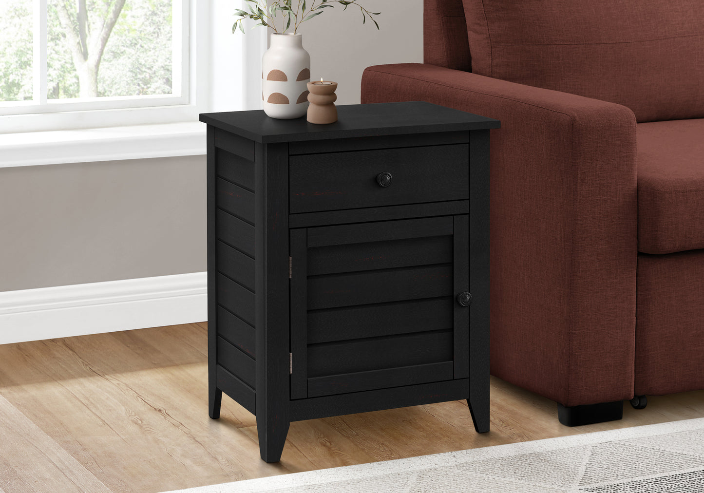 Black farmhouse end table with one drawer and a cabinet door