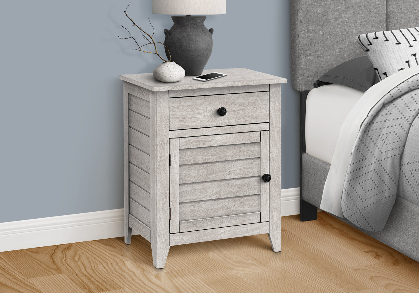 Whitewashed wood nightstand with louvered door and drawer ideal for bedroom storage