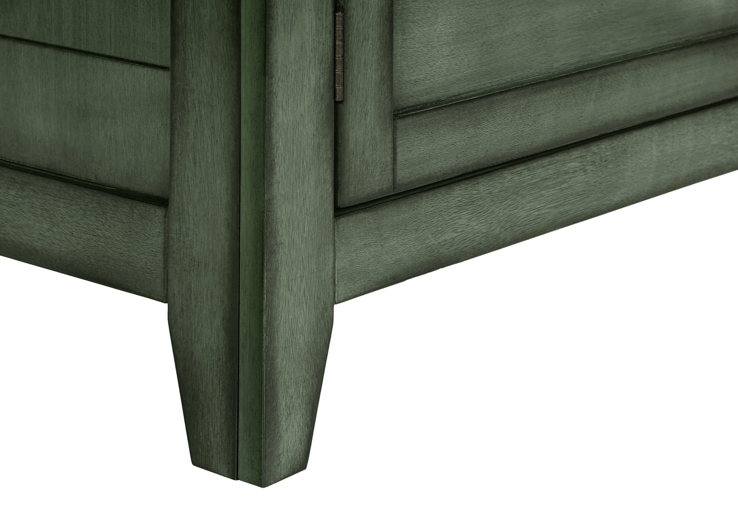 Closeup of a dark green wooden cabinet leg and panel with a visible hinge