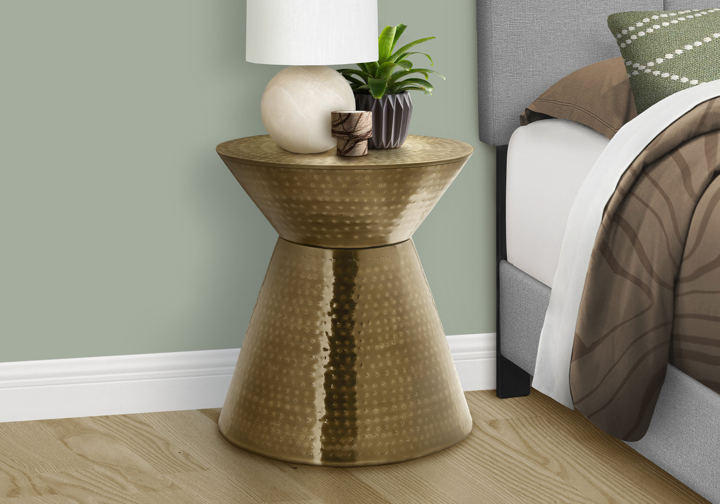 Hammered antique brass hourglass end table with round top and geometric base