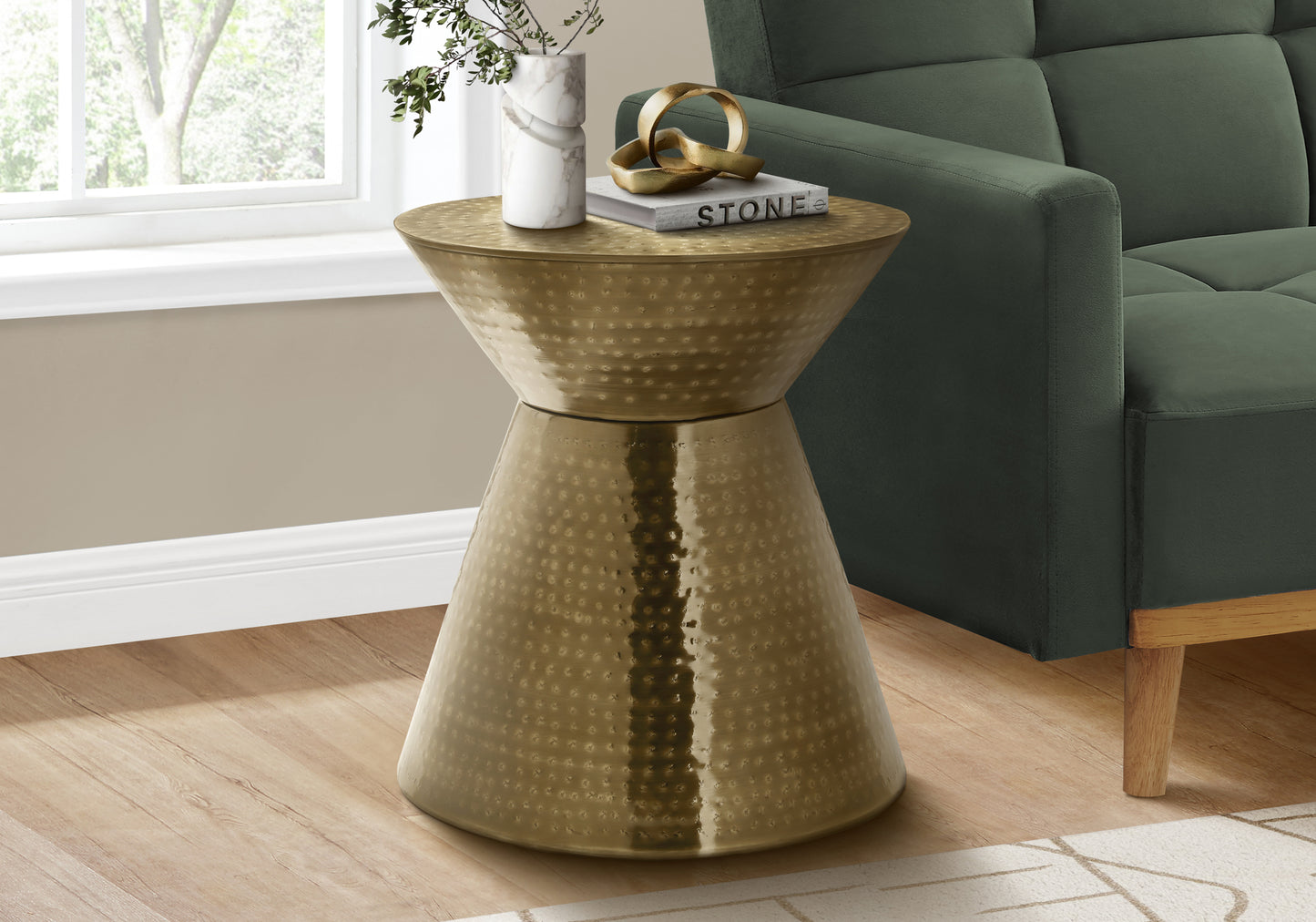 Hammered brass hourglass side table with textured finish