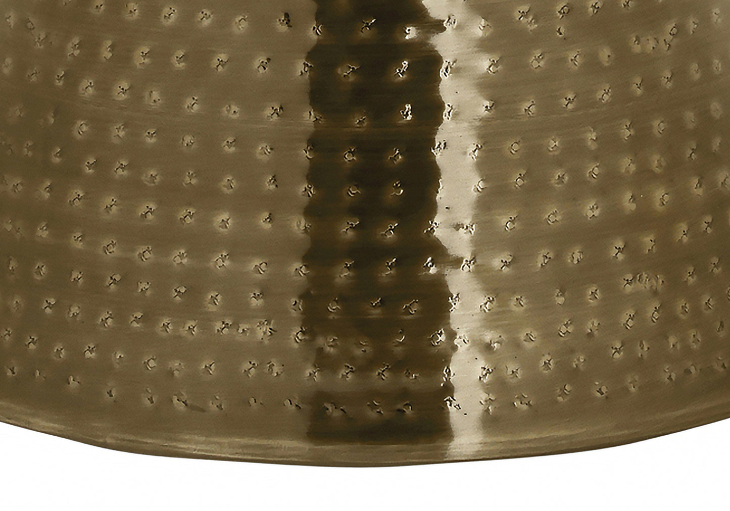 Hammered brass vase with a textured speckled surface and reflective highlights
