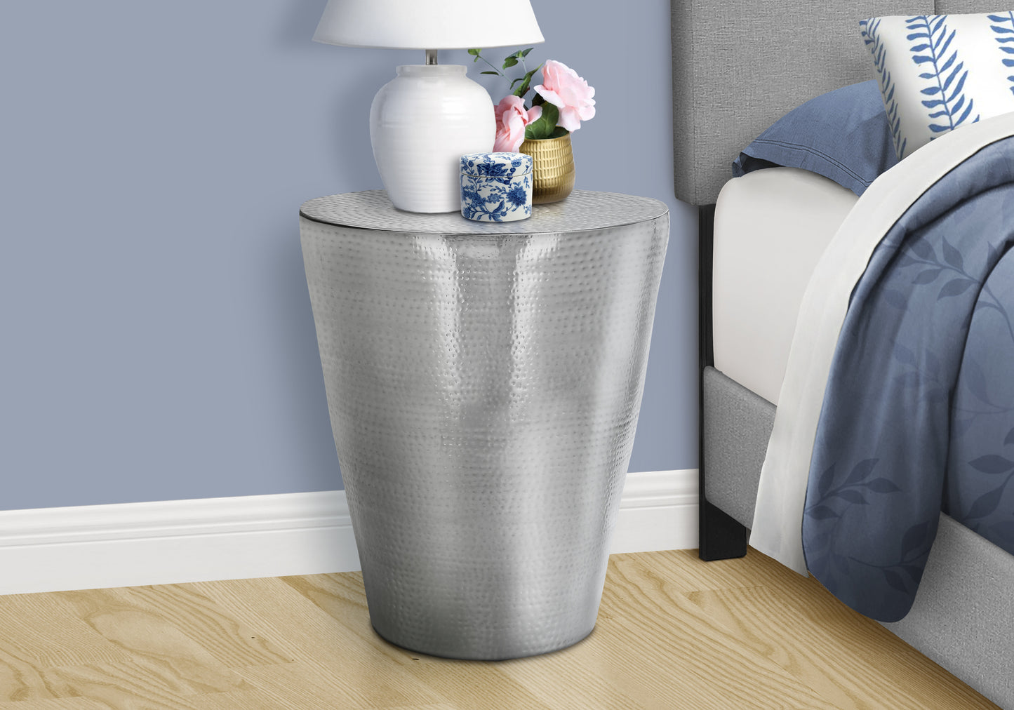 Hammered silver accent table with textured finish ideal for bedside use