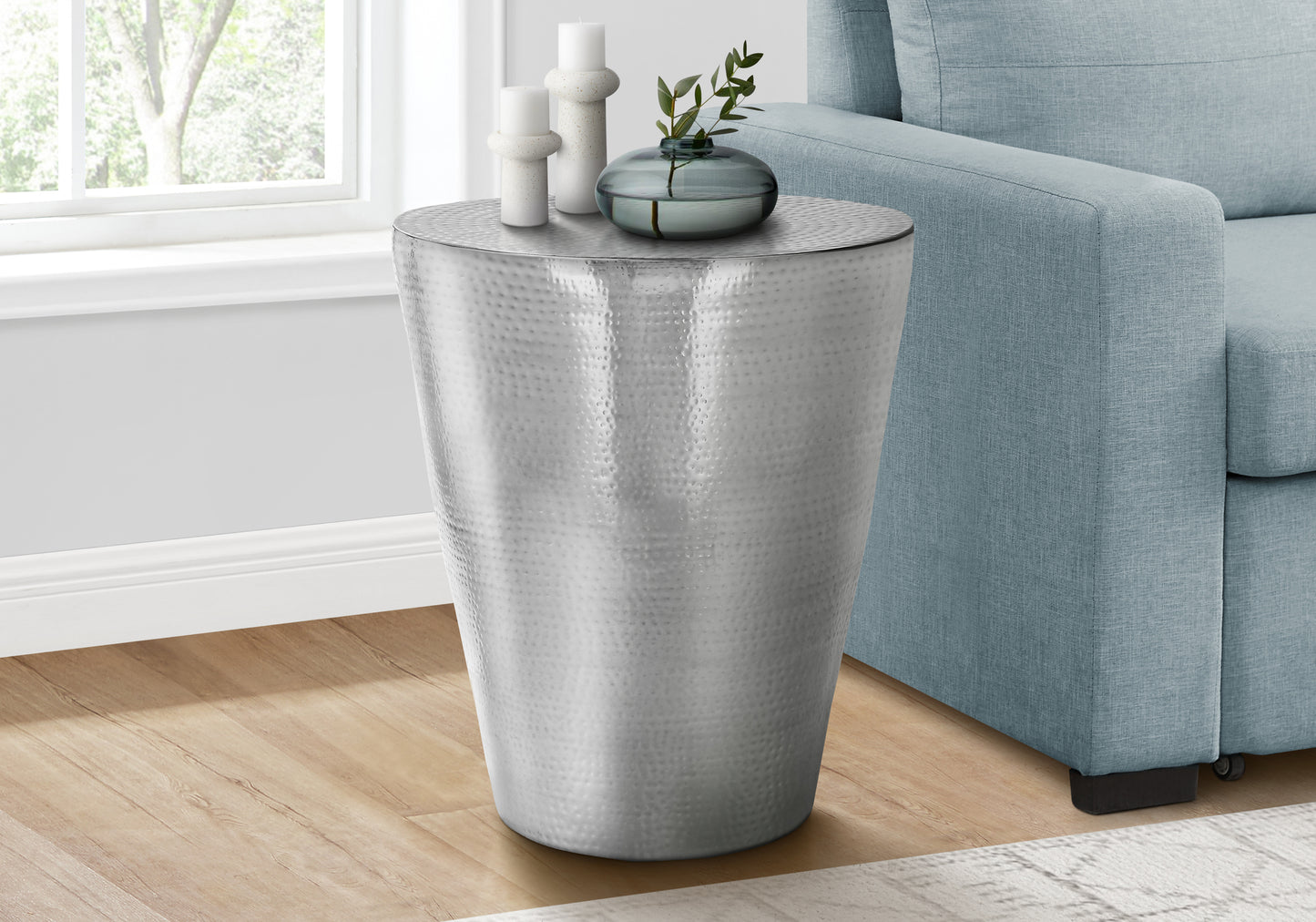 Hammered silver metal accent table with a tapered barrel shape perfect for modern living rooms