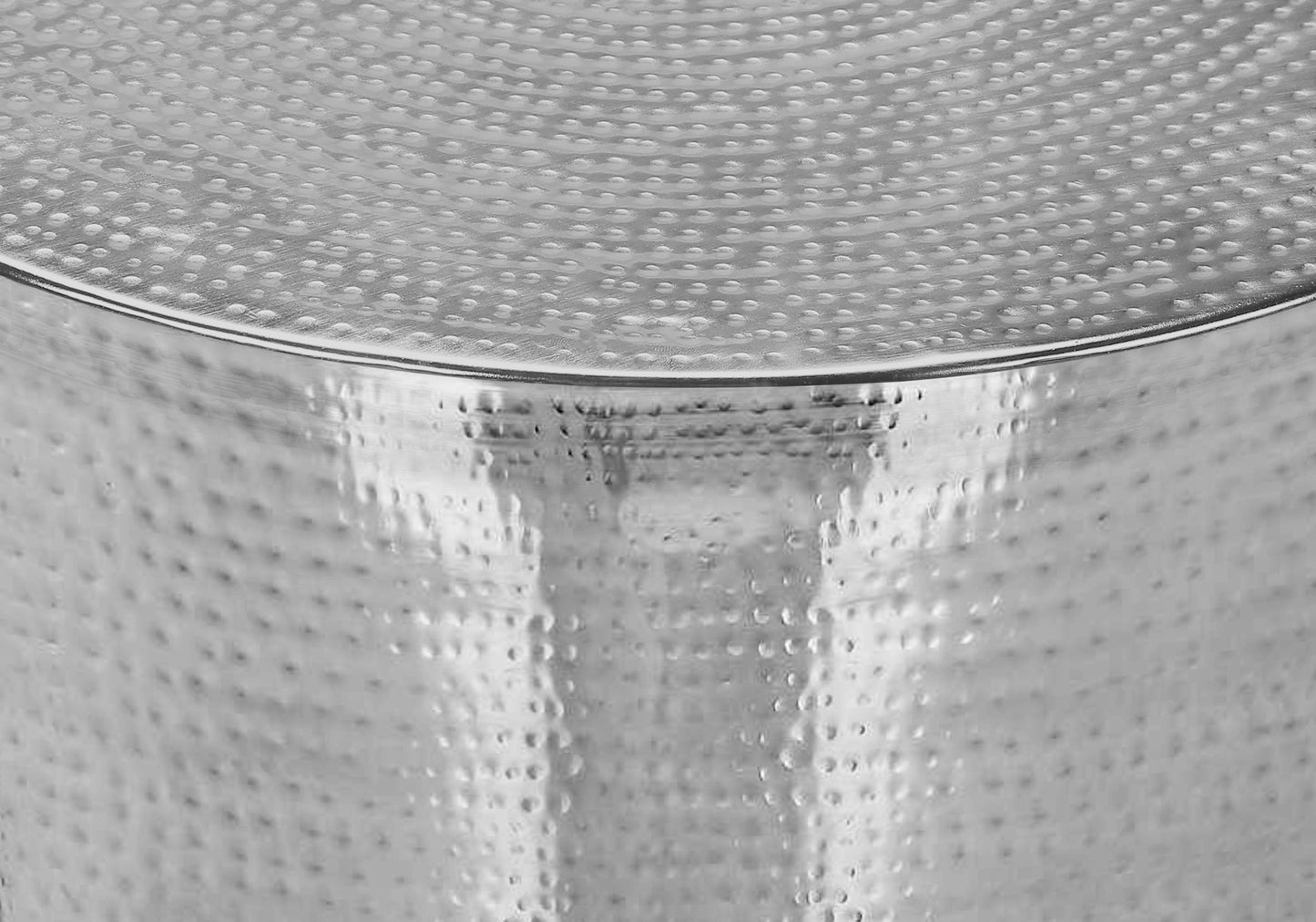 Silver hammered metal side table with textured surface for modern decor