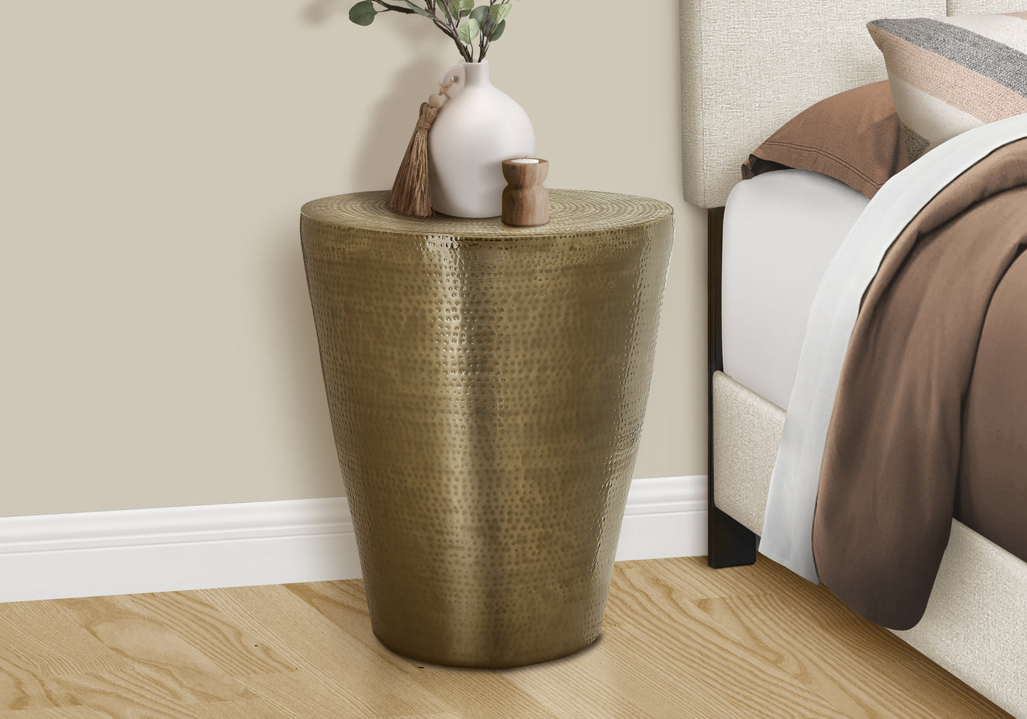 Hammered antique brass barrel end table with textured surface