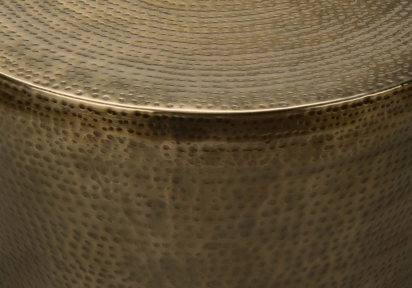 Textured antique brass side table with hammered finish and curved edge