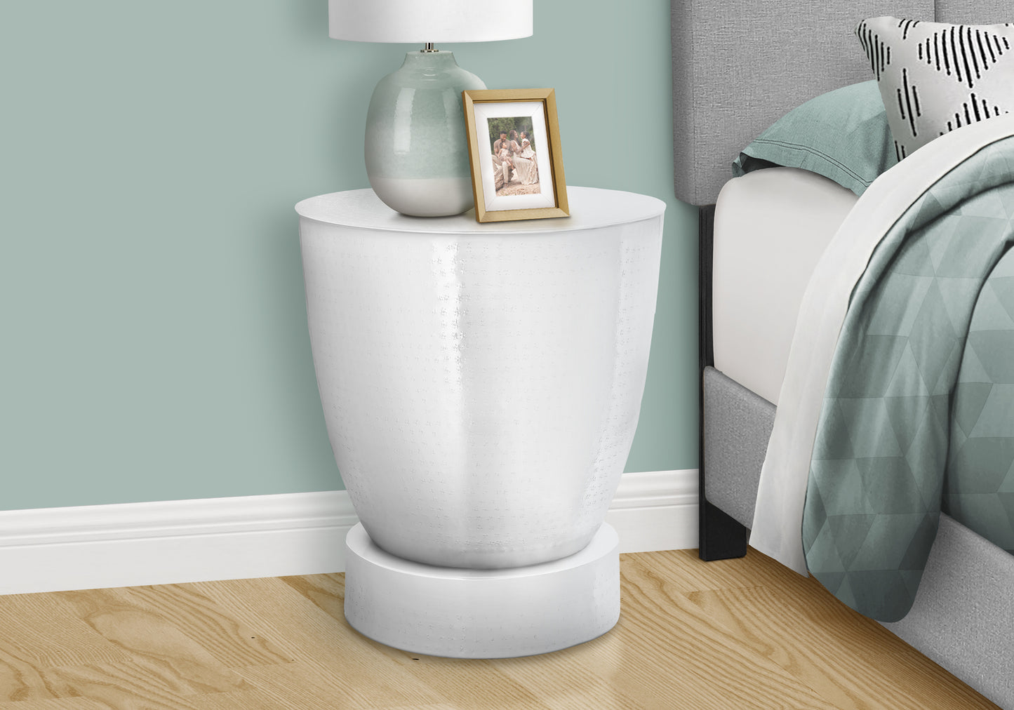 Textured white metal round side table with a golden photo frame