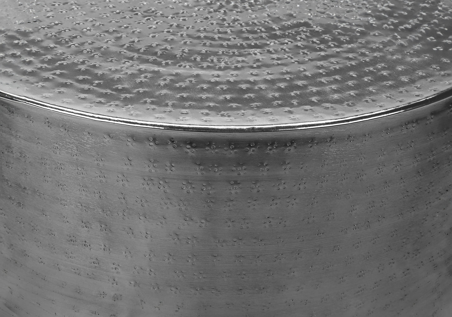 Textured silver metal bowl with hammered finish and reflective rim