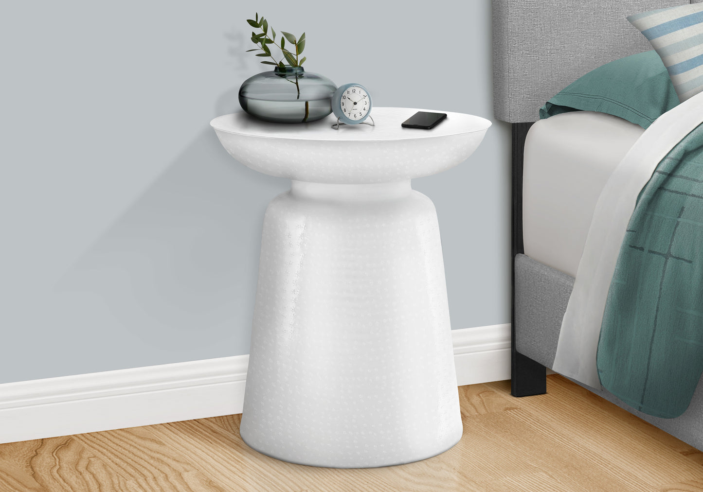 Textured white accent table with a modern design perfect for bedside use