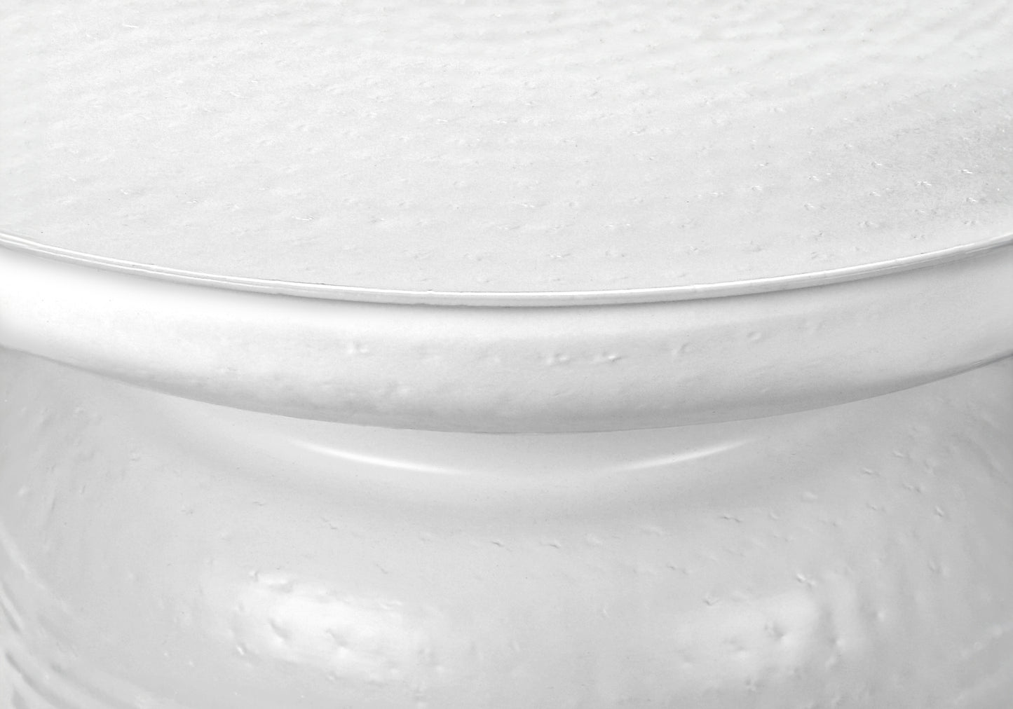 Closeup of a textured white ceramic planter with a smooth rim