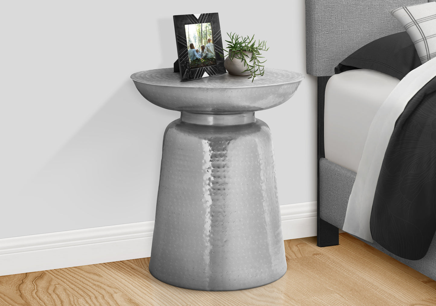 Hammered silver metal accent table with raised dimple texture perfect bedside accent