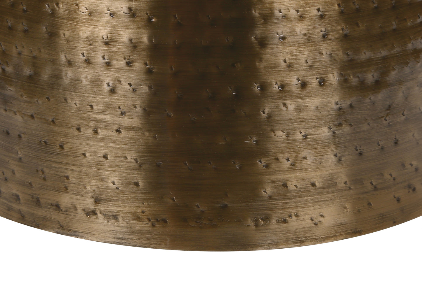Closeup of textured antique brass metal bell with hammered detail